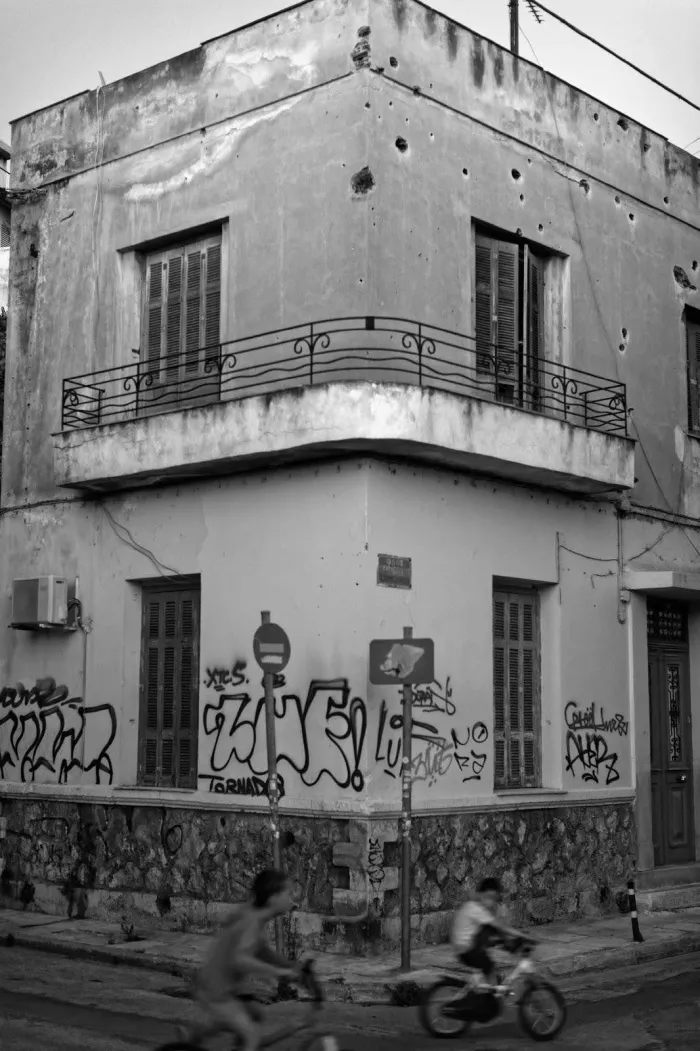 A black and white photo of graffiti-covered building
