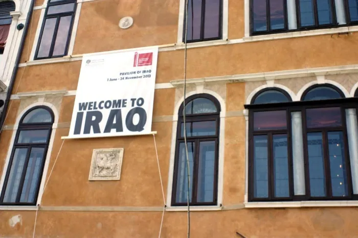 Building with a sign saying Welcome to Iraq