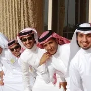A group of men smiling wearing Arab attire