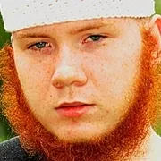 A man with a red beard wearing an Islamic headdress