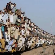 lots of people hanging on a train