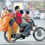 a family riding a motorcycle