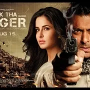Movie poster with a man pointing a gun and a woman behind him