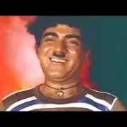 A scene from an old Indian movie featuring a smiling man