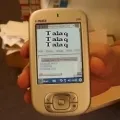 A hand holding an old phone