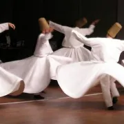 Group of men wearing white dancing traditionally