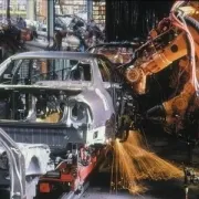 A painting of a car being manufactured in a factory