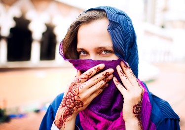 Muslim young woman with hennaed hands