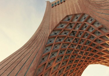 low-angle photography of a brown archway in district 10 in Tehran, Iran under a calm blue sky